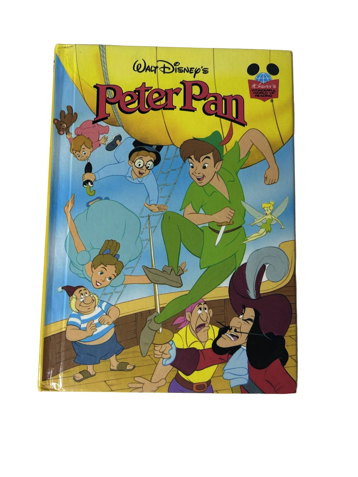 Walt Disney's Peter Pan - front cover showing Peter Pan flying with Tinker Bell, Captain Hook, and the Darling children on yellow background