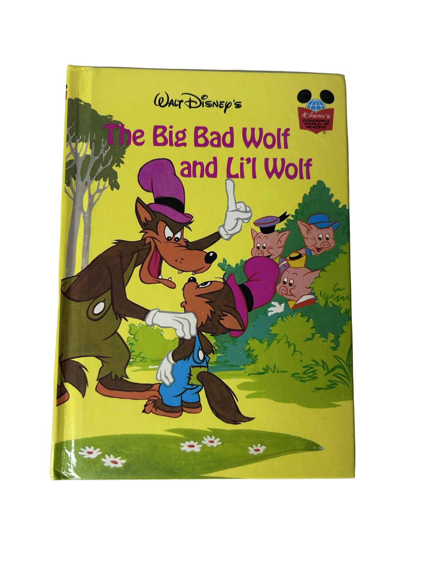 Walt Disney's The Big Bad Wolf and Li'l Wolf - front cover showing Big Bad Wolf scolding Li'l Wolf while Three Little Pigs watch from bushes on yellow background